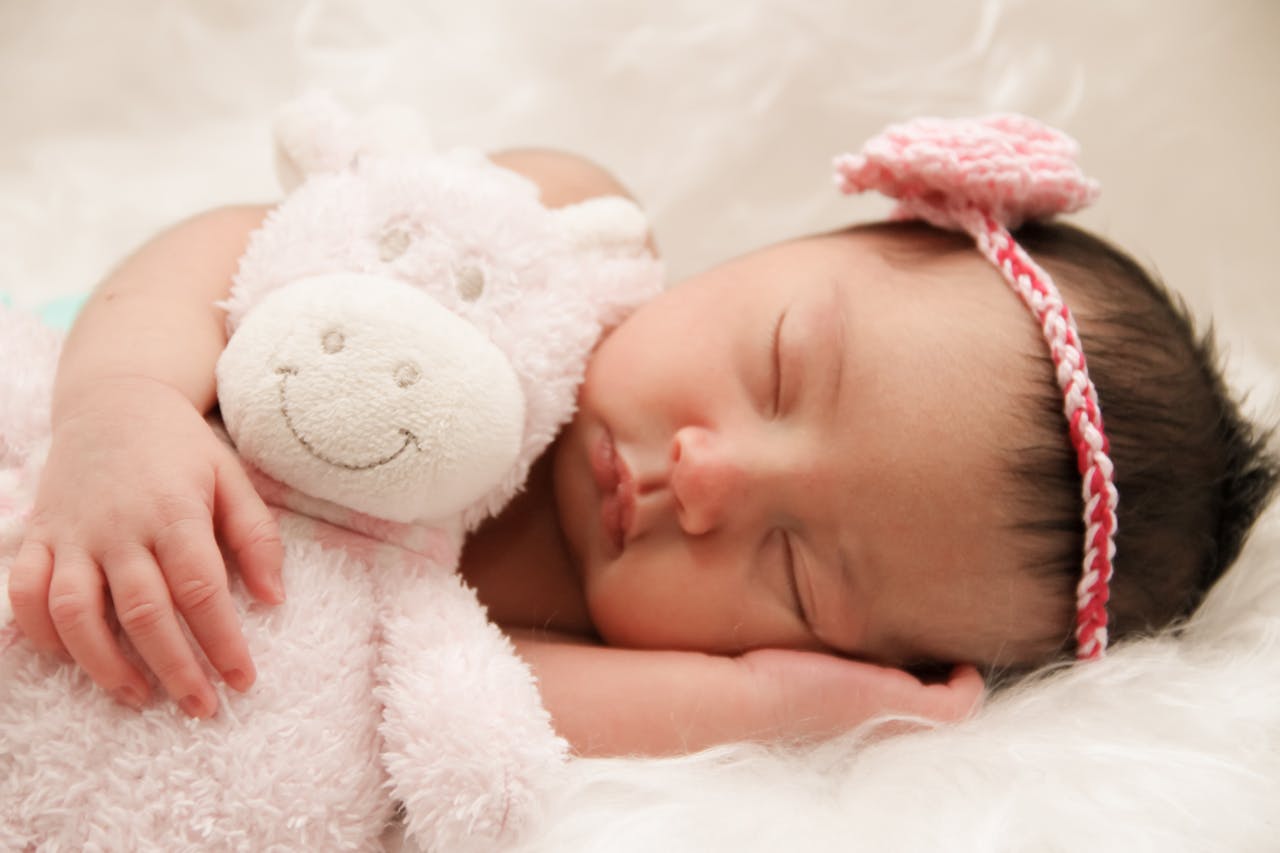 baby sleeping with teddybear