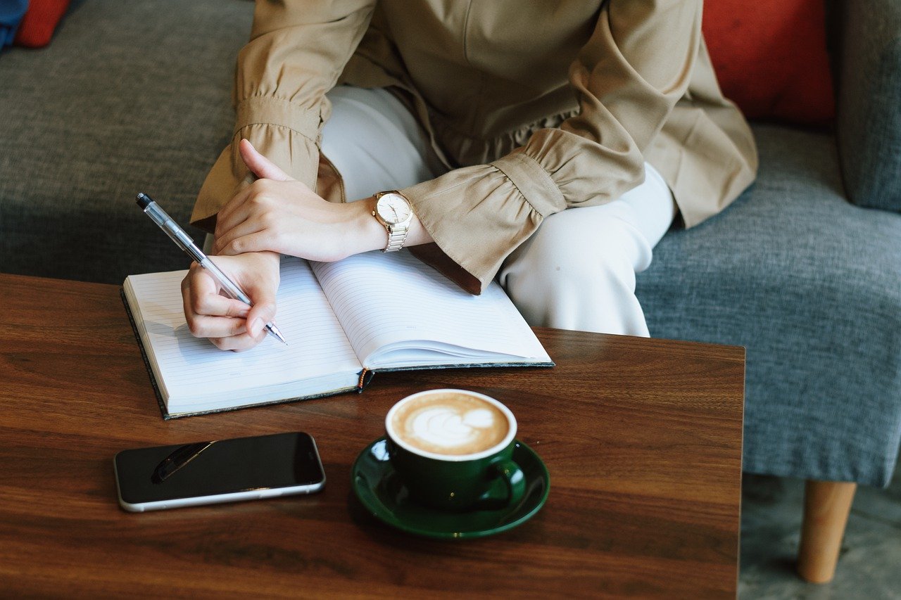 woman writing in book